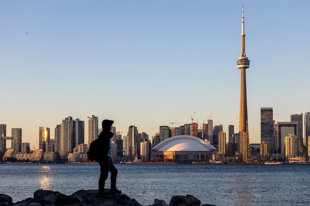 a man standing on a rock near the water